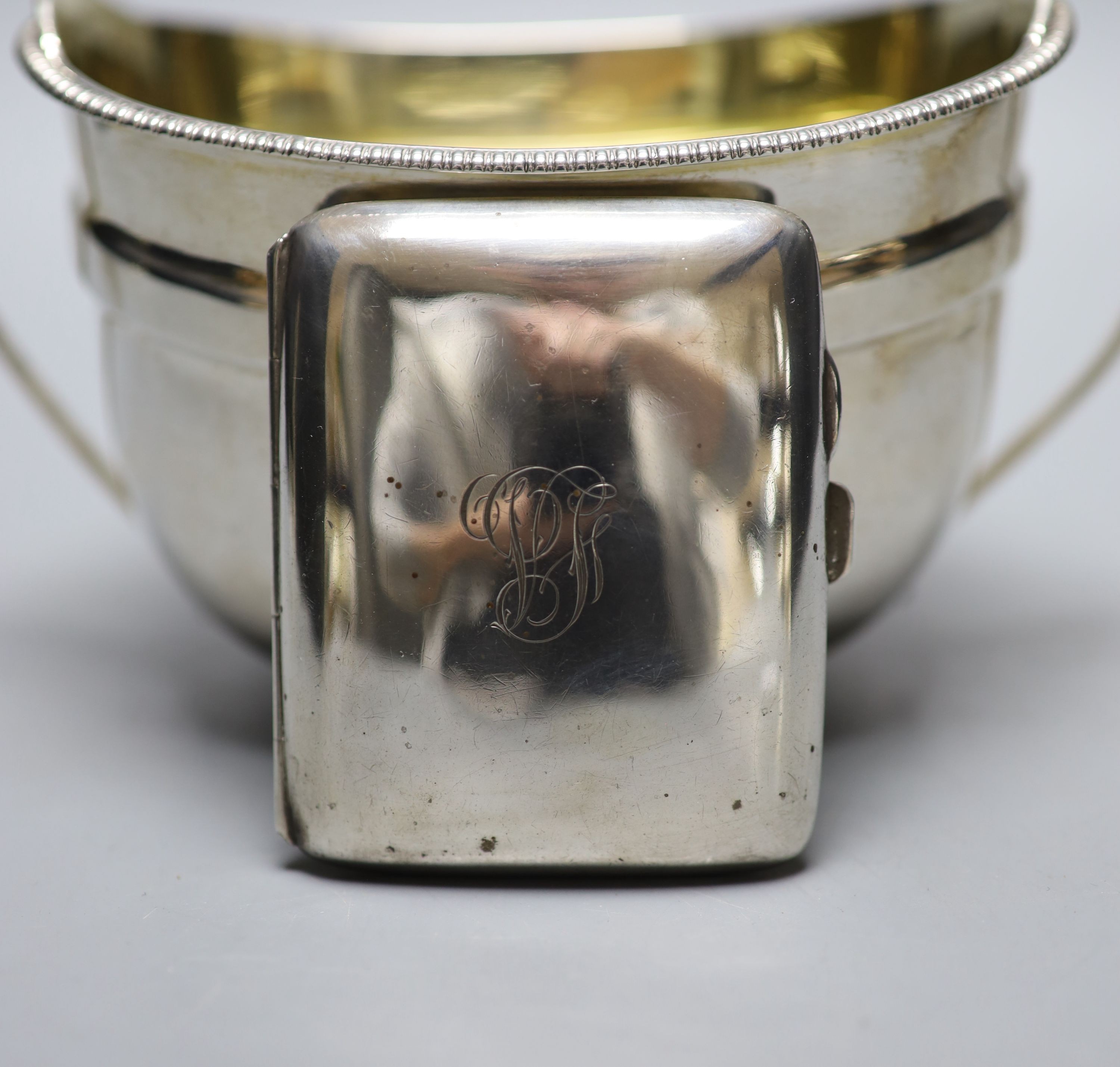 A George III silver two handled sugar bowl, John Emes, London, 1807, height 11.2cm, together with a later silver cigarette case, gross 11oz.